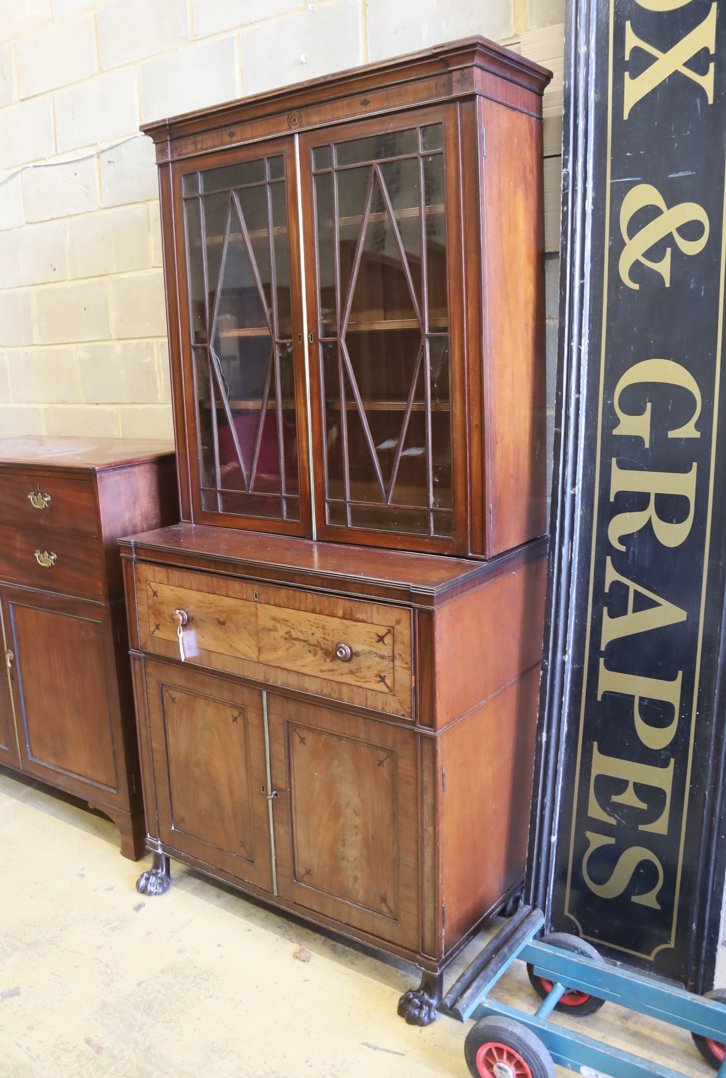 A Regency mahogany secretaire bookcase on lion paws feet, length 100cm, depth 56cm, height 216cm